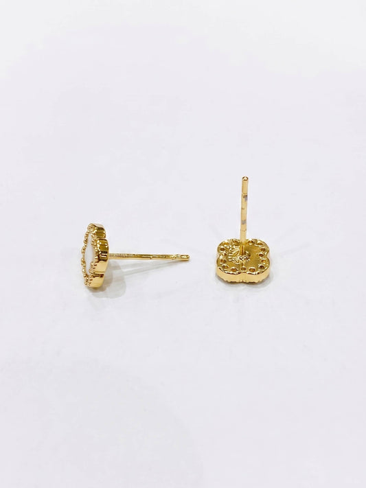 Gold earrings on a white background