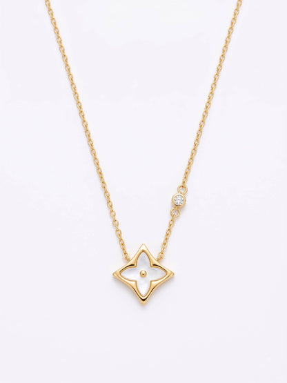 Gold star-shaped pendant necklace on a white background