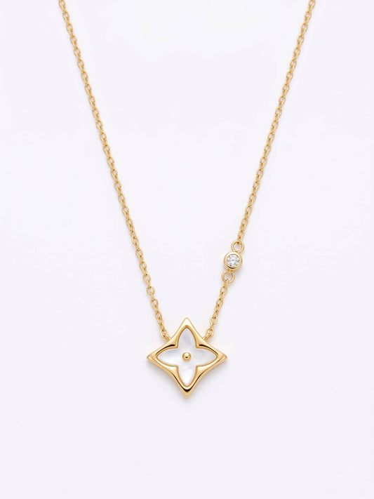 Gold star-shaped pendant necklace on a white background