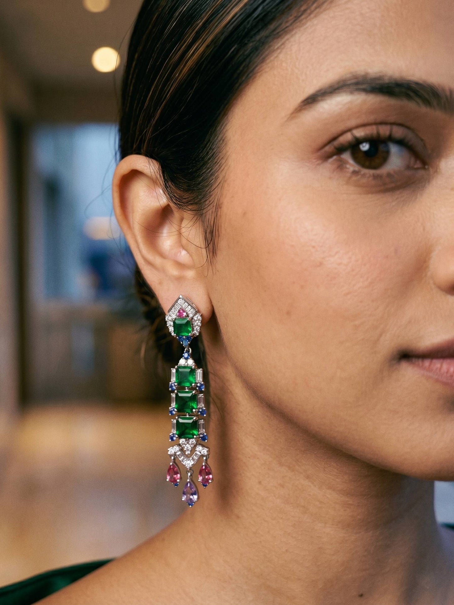 Close-up of a woman wearing colorful earrings with a blurred background