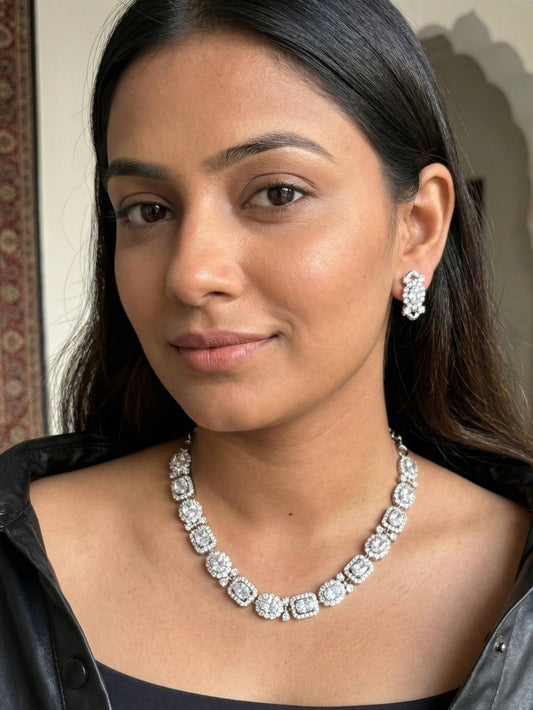 Woman wearing a diamond necklace and earrings indoors