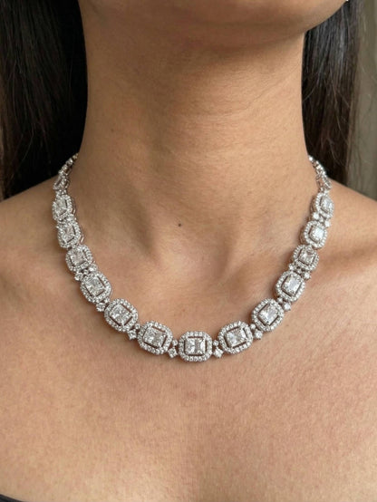 Silver necklace with diamond-like stones worn by a person