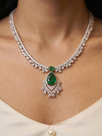 Delicate necklace with a green gemstone and diamonds on a person's neck