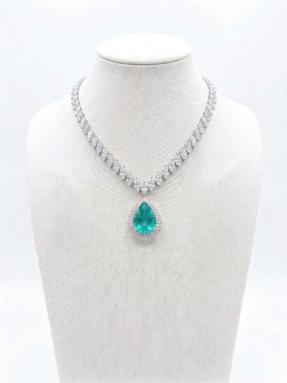 Necklace with a green teardrop pendant on a mannequin bust against a white background