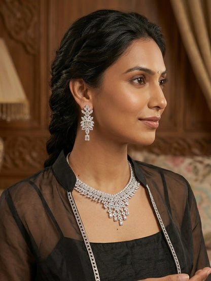Woman wearing a diamond necklace and earrings in an elegant setting