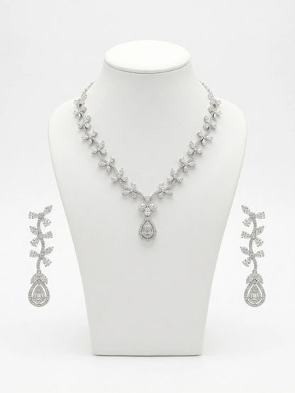 Silver necklace and earrings set on a white mannequin bust.