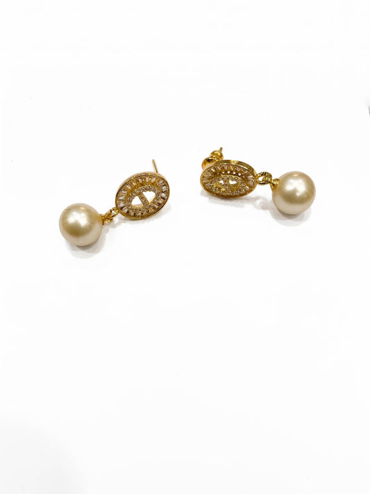 Pair of gold earrings with pearls on a white background