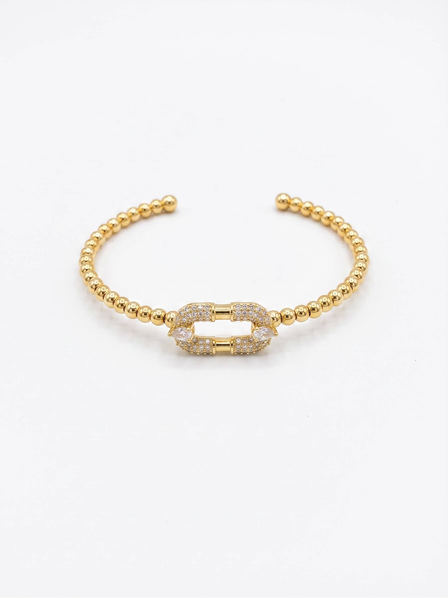Close-up of Gold Beaded Bracelet with Crystal Link