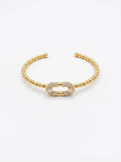 Close-up of Gold Beaded Bracelet with Crystal Link