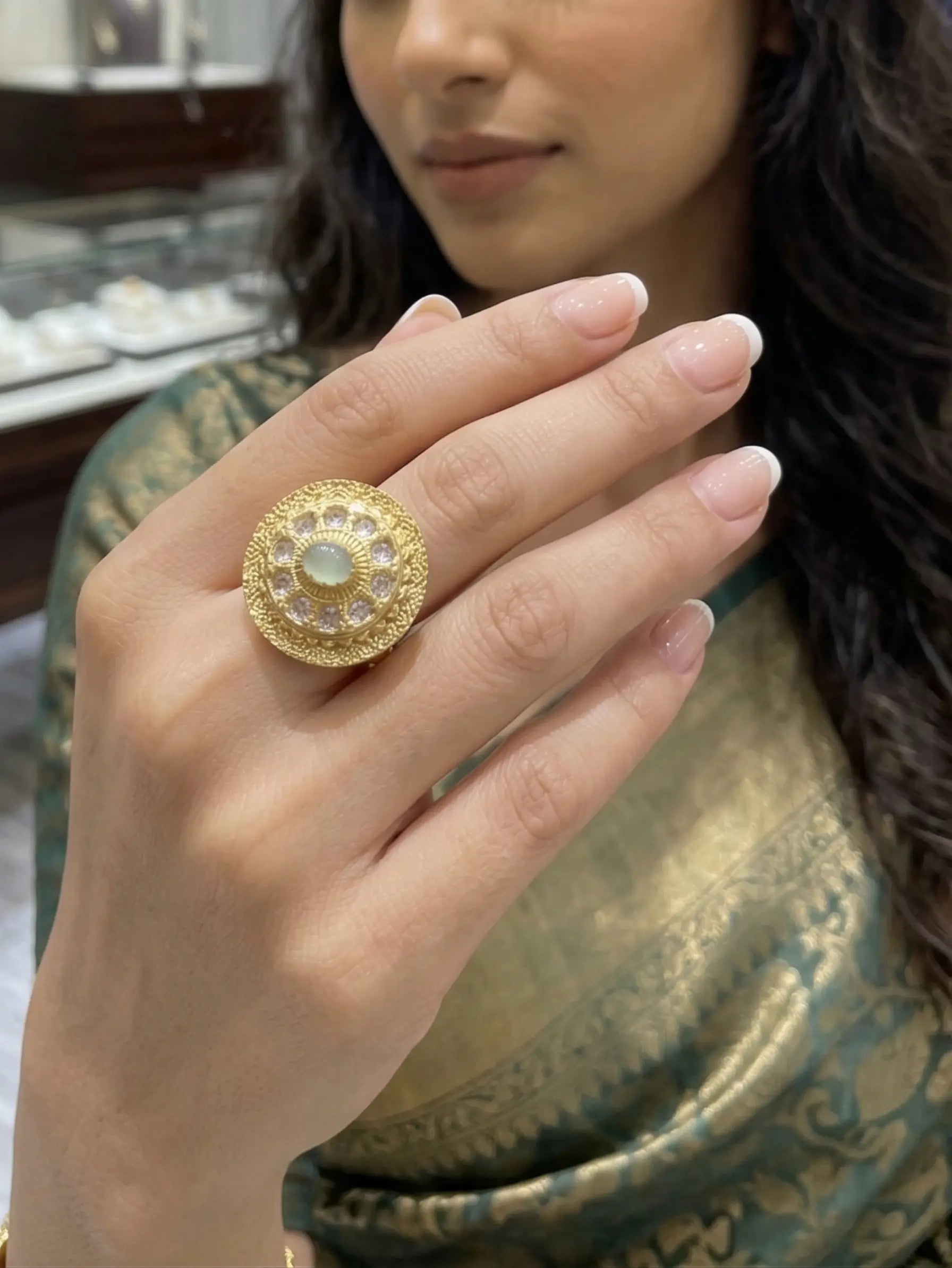 Handcrafted gold filigree ring for women featuring a mint green oval stone and sparkling cubic zirconia accents on a clean white background.