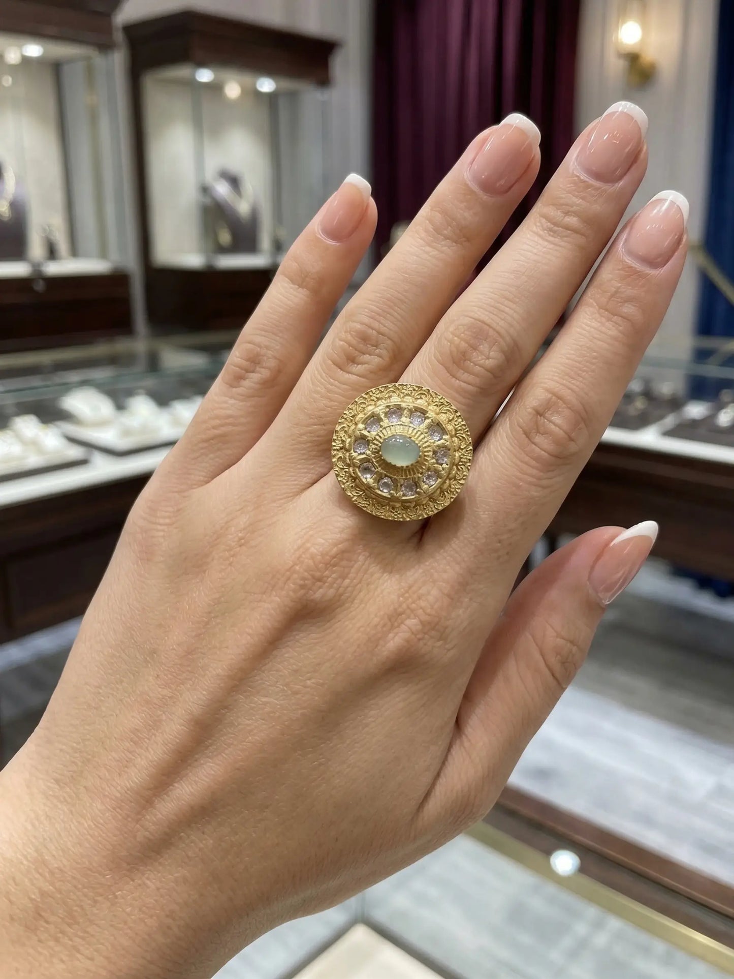 Elegant ladies' ring with a mint green gemstone worn on a female hand, showcasing its premium fashion jewelry design for weddings and parties.
