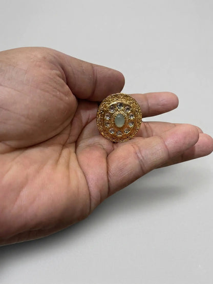 Close-up of a Swarovski-style stone ring for women with high-clarity CZ stones and intricate gold-plated circular patterns.