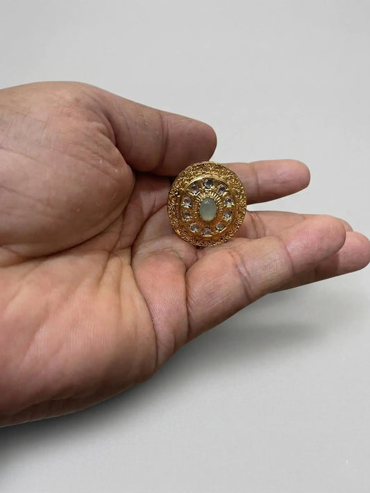 Close-up of a Swarovski-style stone ring for women with high-clarity CZ stones and intricate gold-plated circular patterns.