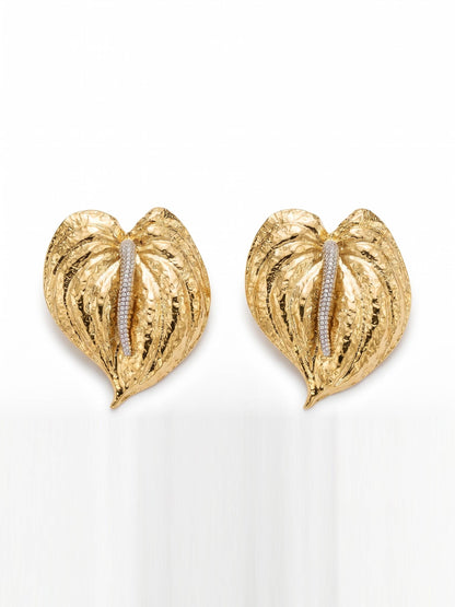 Gold leaf-shaped earrings with embedded stones on a white background