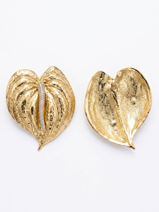 Gold heart-shaped earrings on a white background