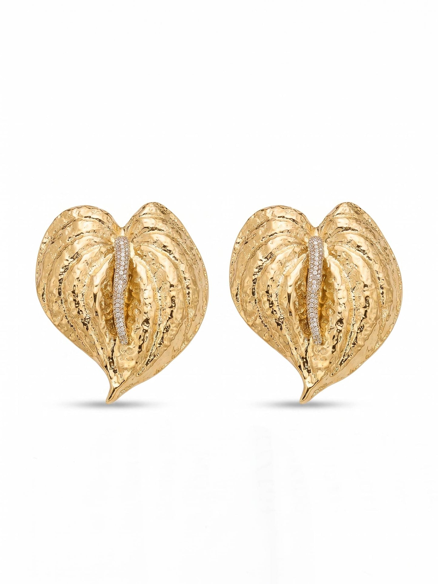 Gold heart-shaped earrings with embedded diamonds on a white background