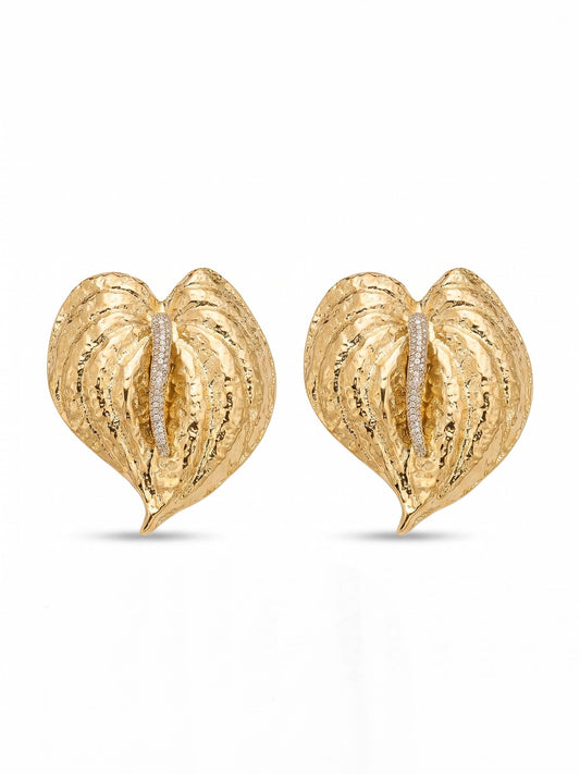 Gold heart-shaped earrings with embedded diamonds on a white background