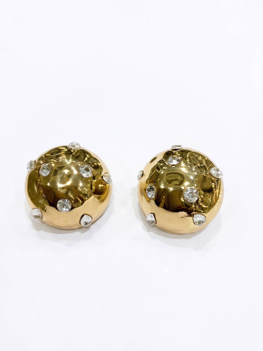 Gold earrings with gemstones on a white background