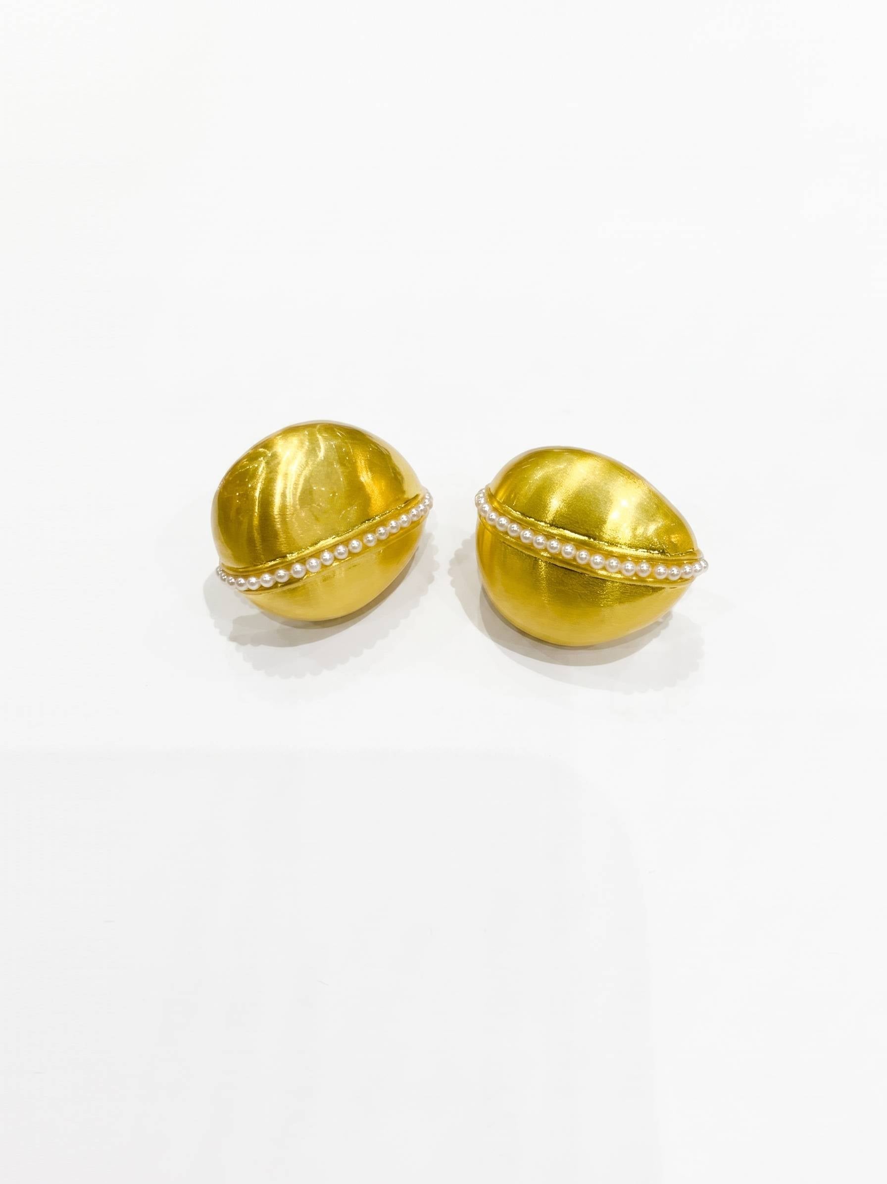Pair of gold earrings with a white background