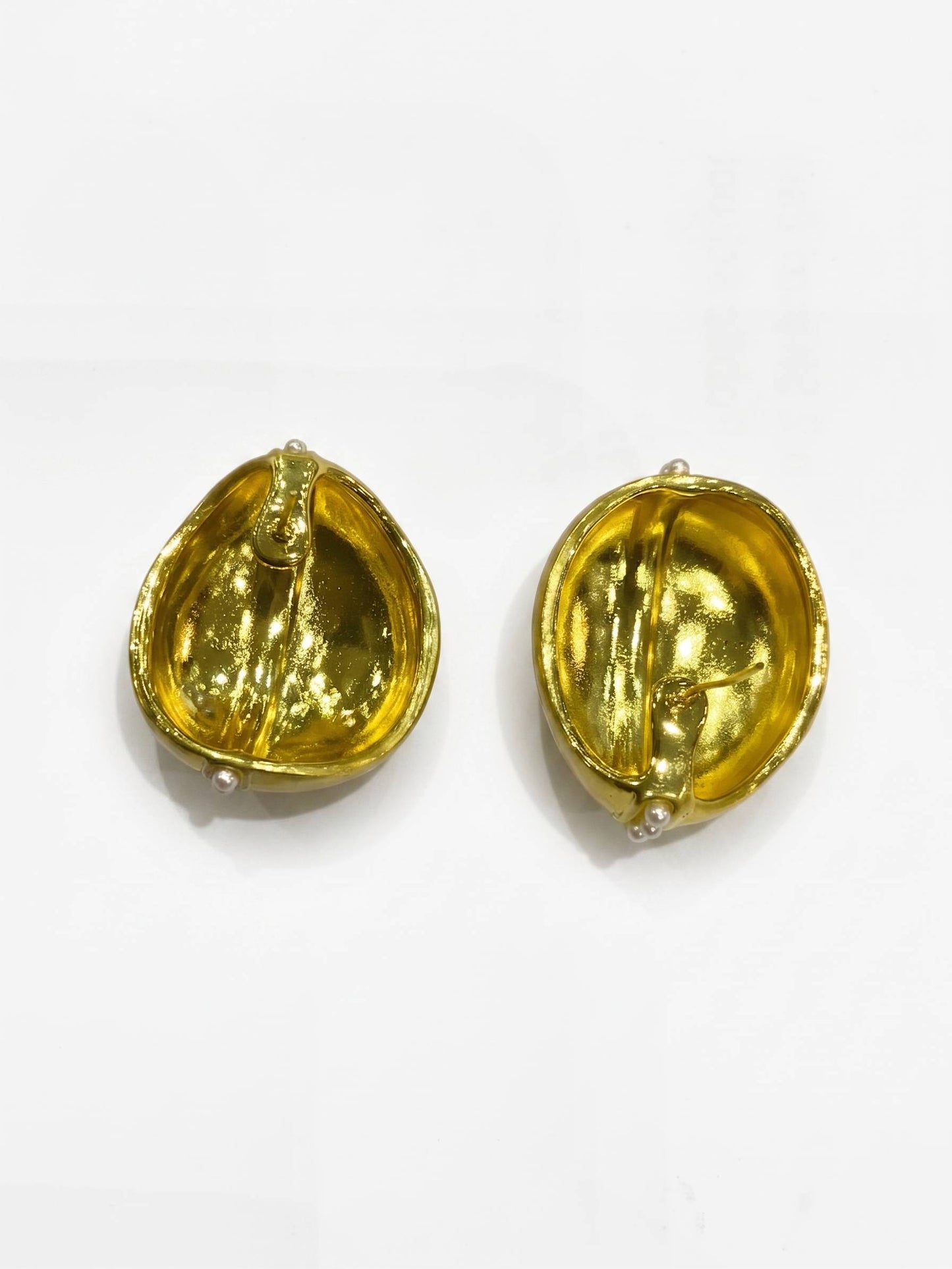 Pair of gold earrings on a white background