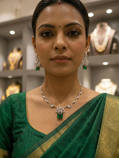 Woman wearing a green saree with jewelry in an indoor setting