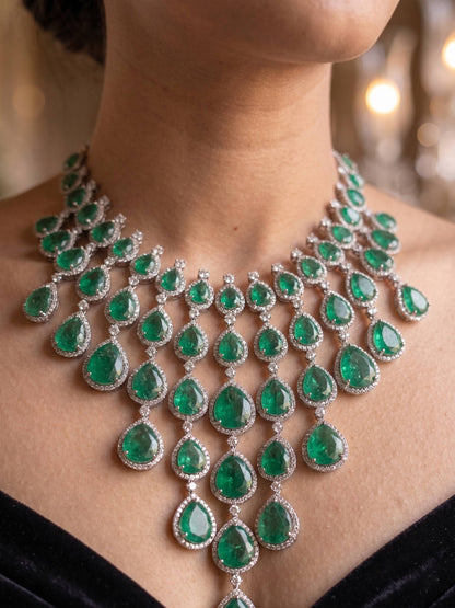 Luxurious emerald necklace on a person with a blurred background