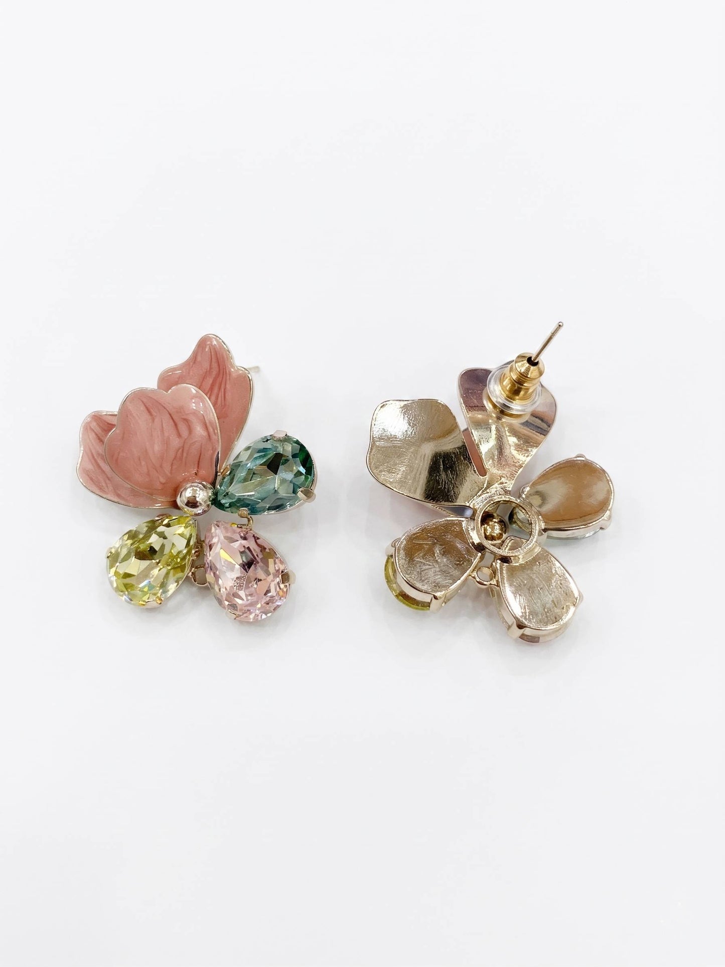 Pair of floral earrings with gemstones on a white background