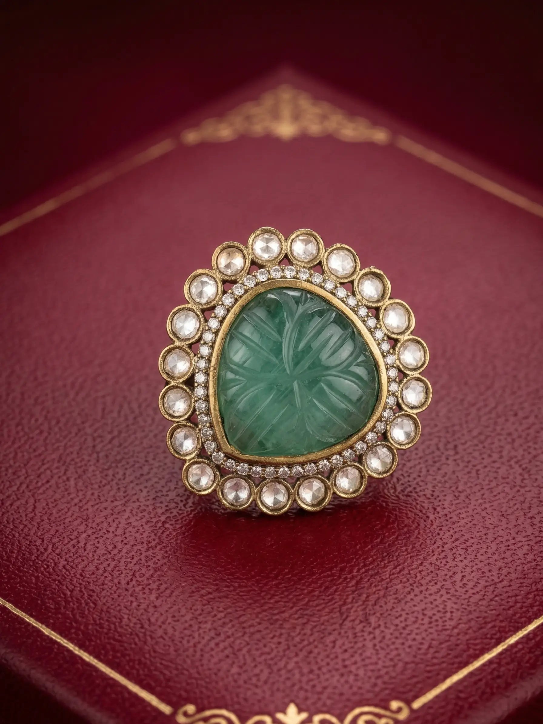 Adjustable ladies ring with emerald green carved centerpiece