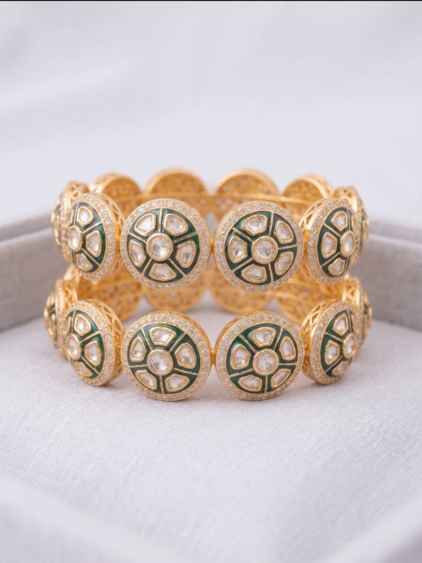 Gold and green bracelet on a white background