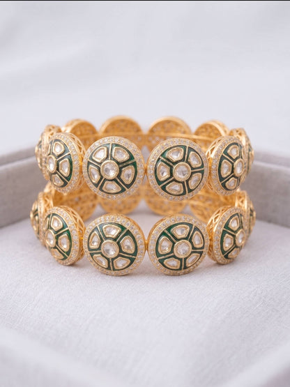 Gold and green bracelet on a white background