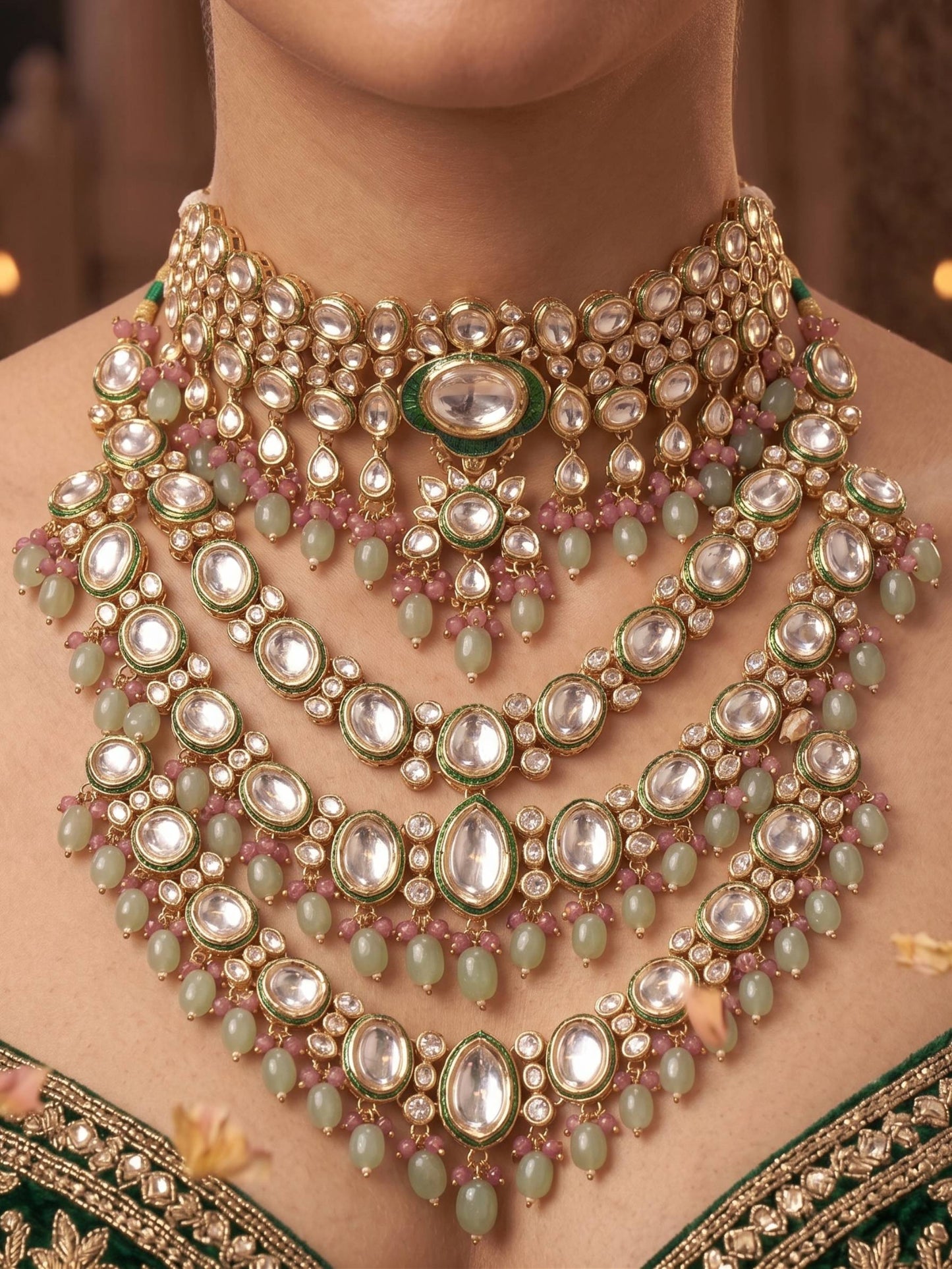 Close-up of a person wearing an elaborate necklace with green and gold accents.