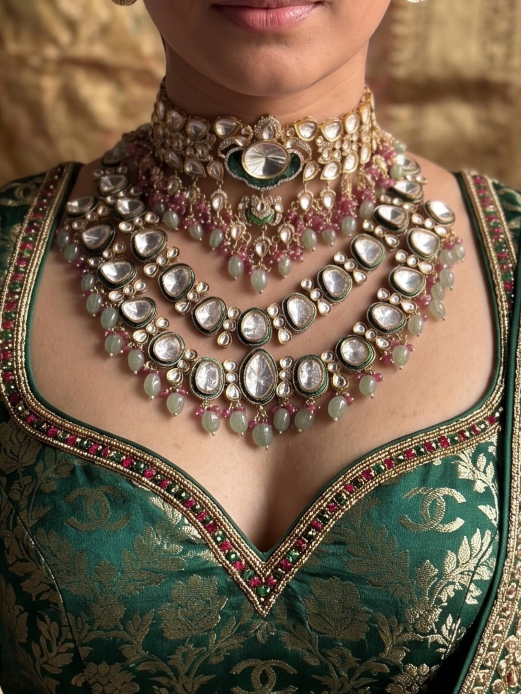 Close-up of a person wearing an ornate necklace and traditional outfit with intricate designs.