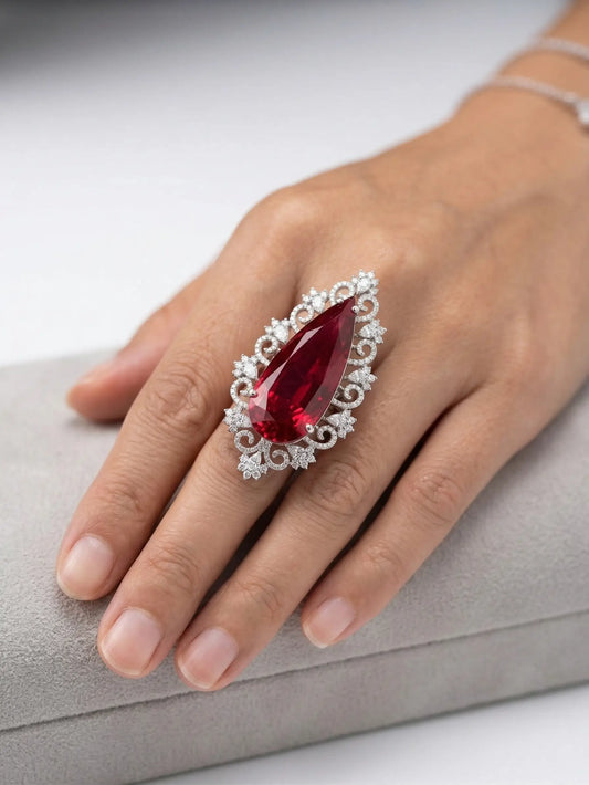 Large teardrop red stone ring for women featuring a vintage floral silver setting.