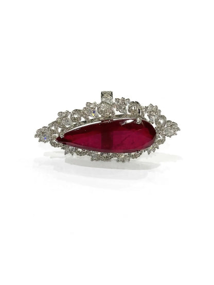 Elegant ruby-red cubic zirconia fashion ring for women displayed in a jewelry boutique setting.