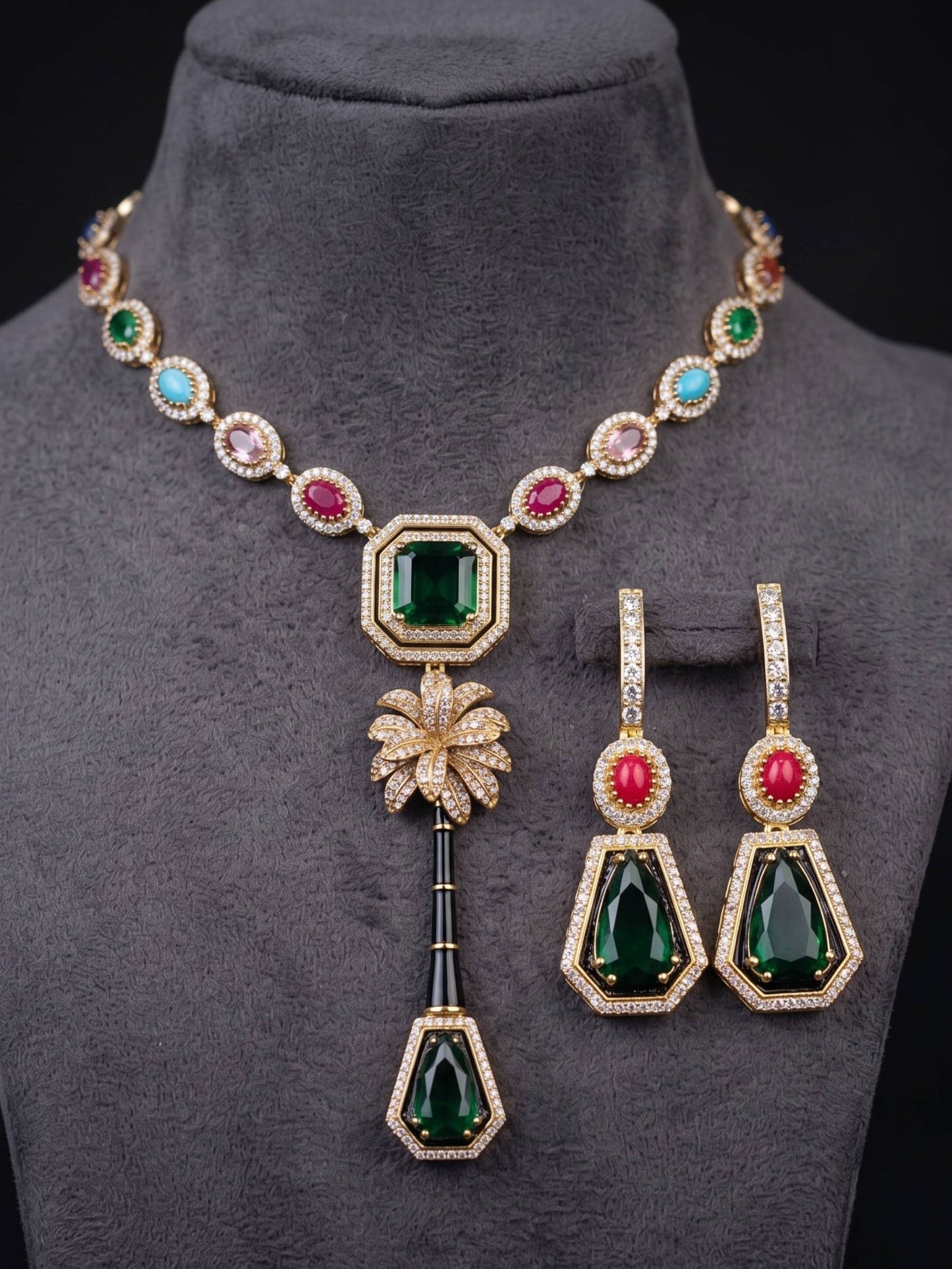 Jewelry set with necklace and earrings featuring green and red gemstones on a mannequin.