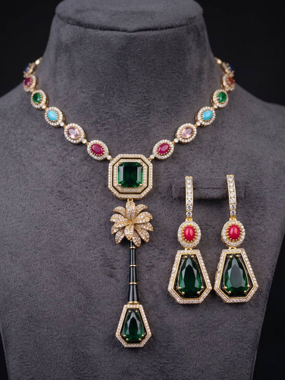 Jewelry set with necklace and earrings featuring green and red gemstones on a mannequin.