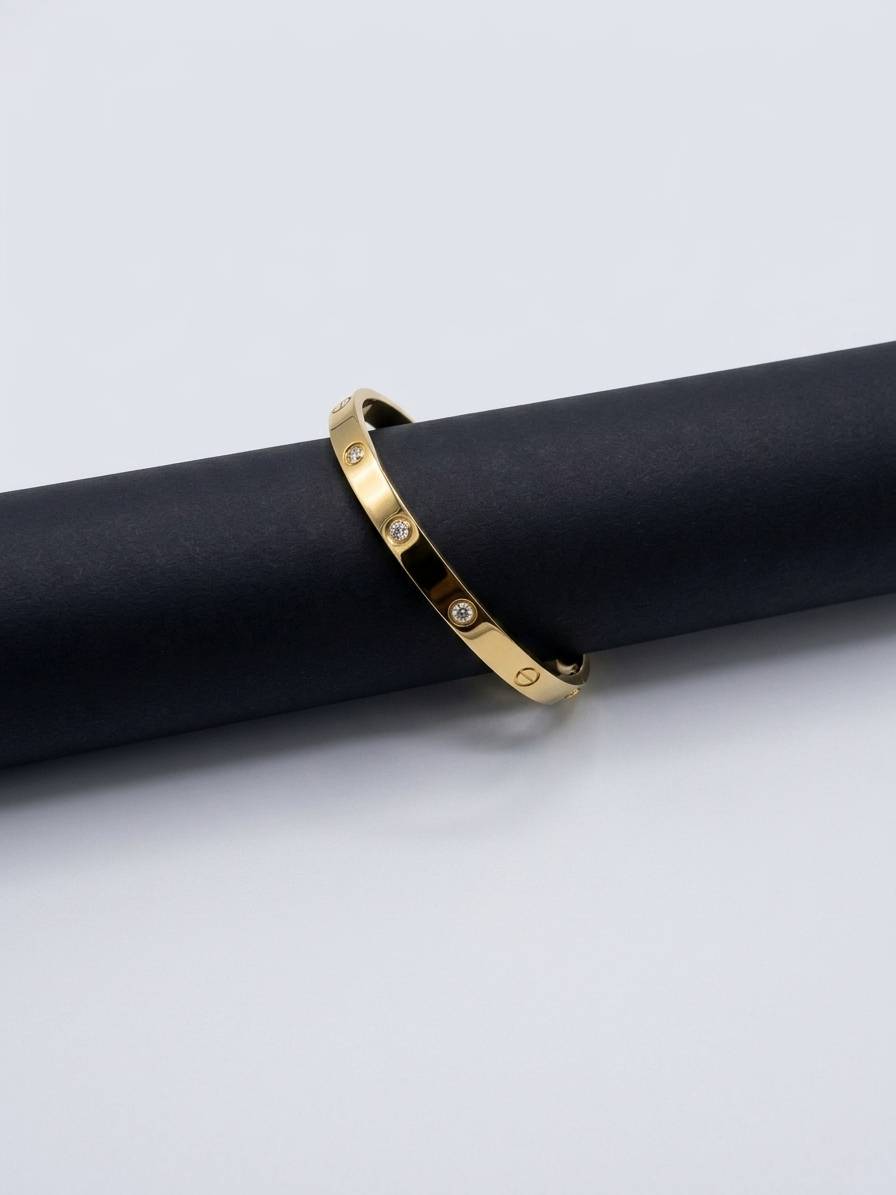 Sleek bangle with stone embellishments and engraved details.