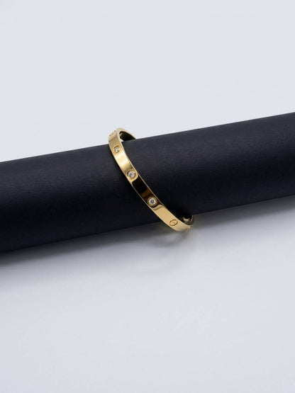 Sleek bangle with stone embellishments and engraved details.
