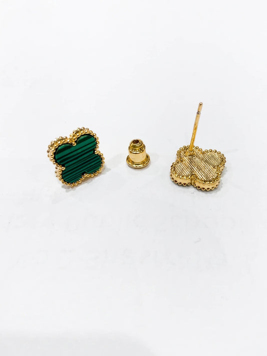 Heart-shaped green stone earrings with gold posts on a white background