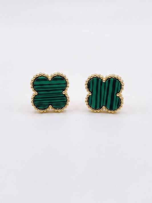 Pair of green clover-shaped earrings with gold frames on a white background