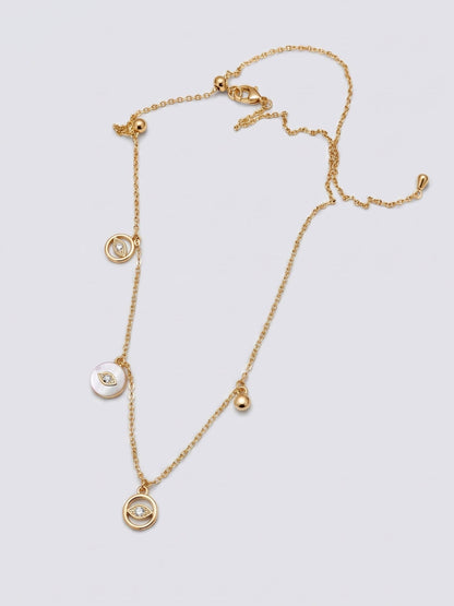 Gold necklace with three circular pendants on a light gray background