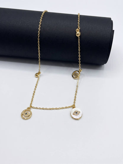 Gold chain necklace with circular pendants on a white background