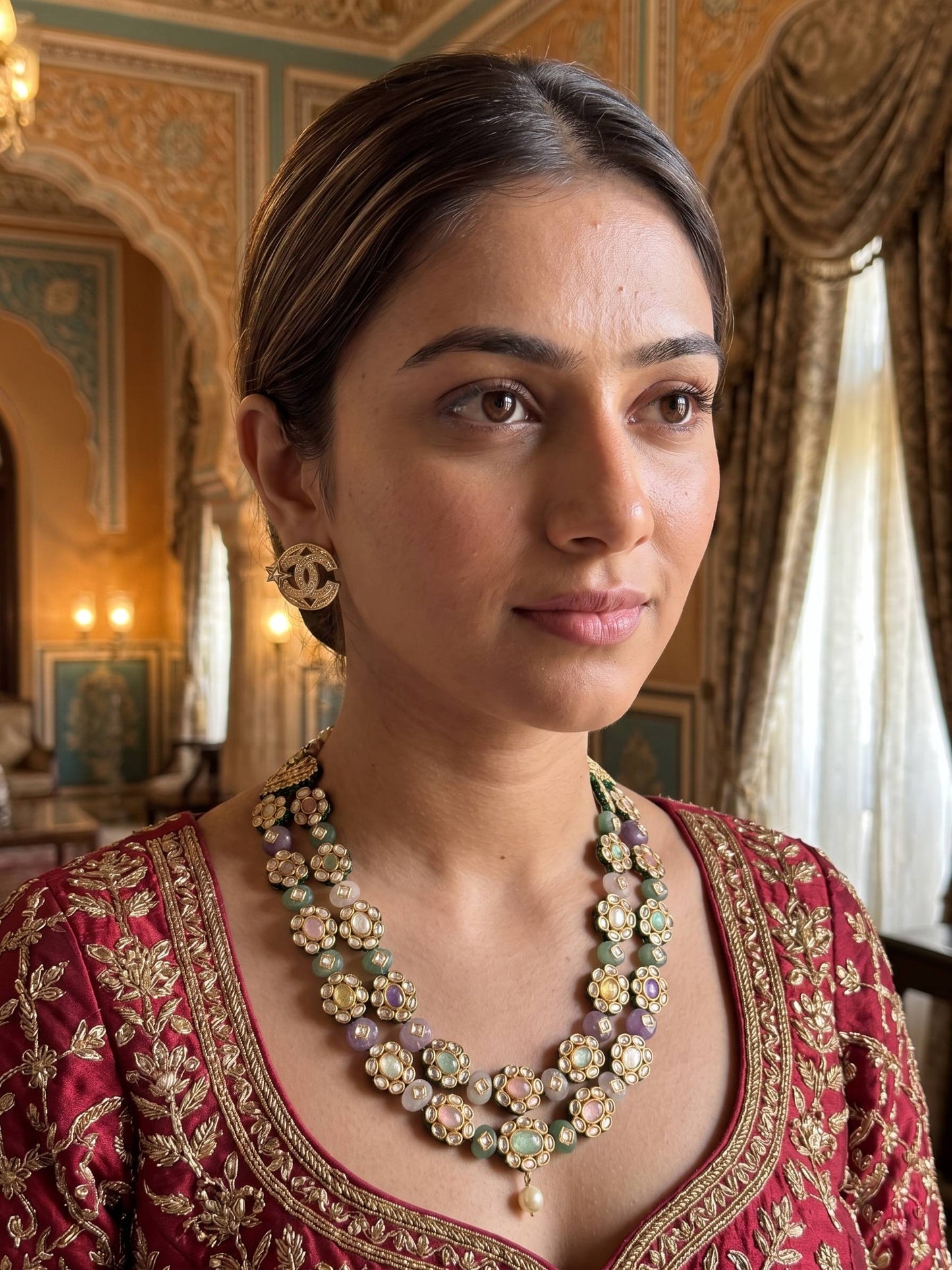 Woman wearing traditional jewelry in an ornate room