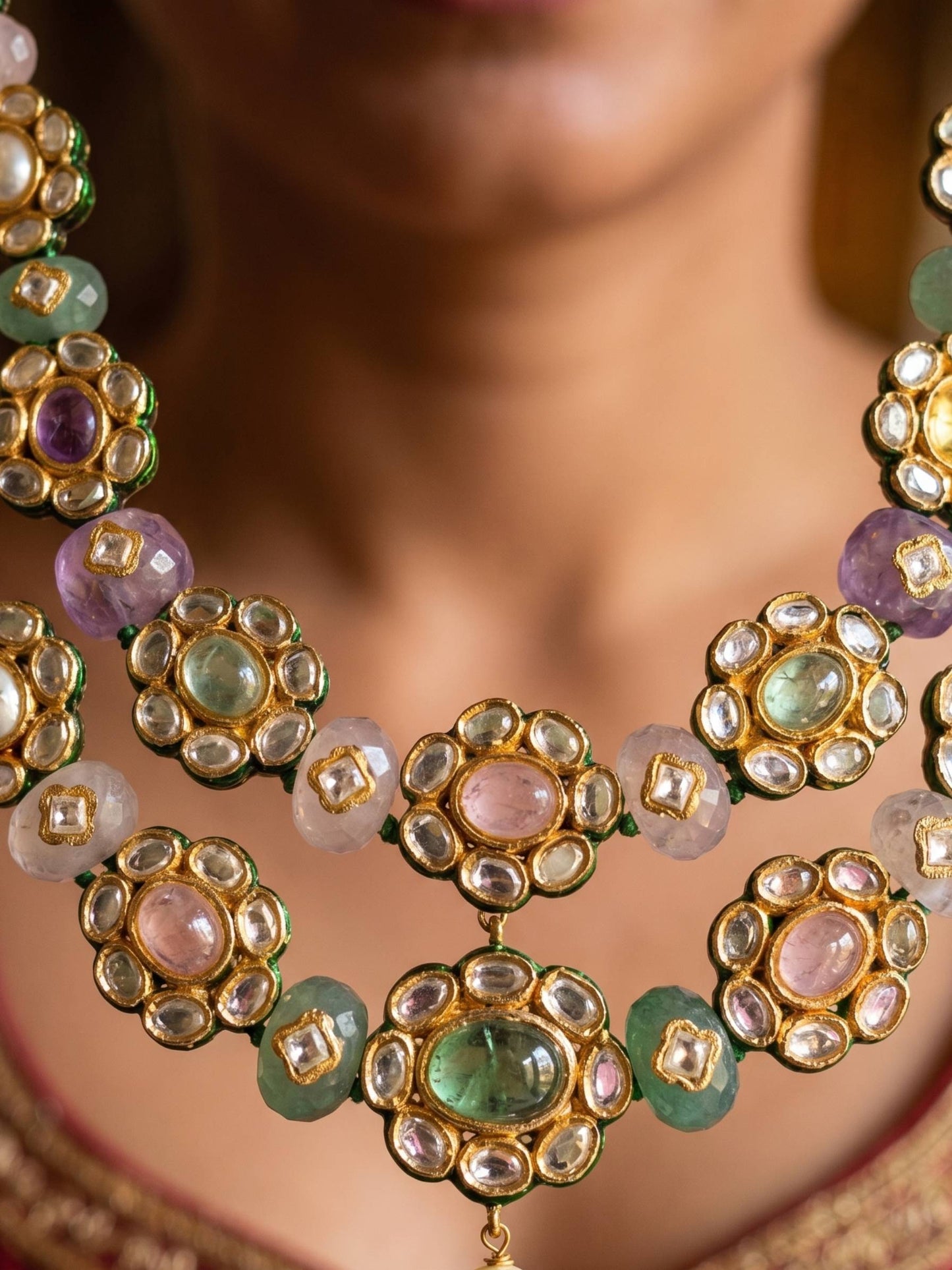 Close-up of a ornate necklace with gemstones on a blurred background