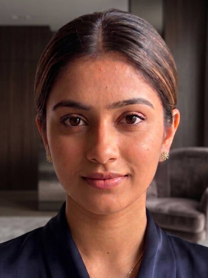 Woman with a neutral expression in an indoor setting