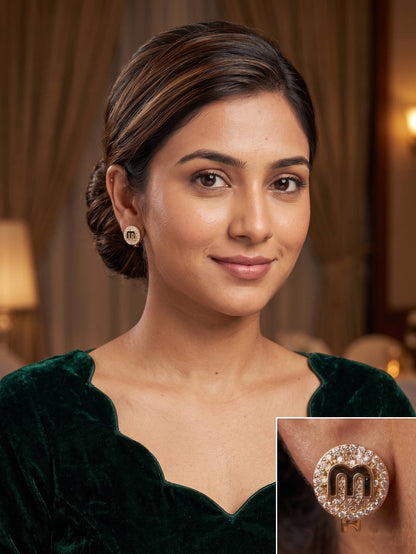 Woman wearing a green velvet dress with a close-up of an earring in a warm-toned indoor setting.