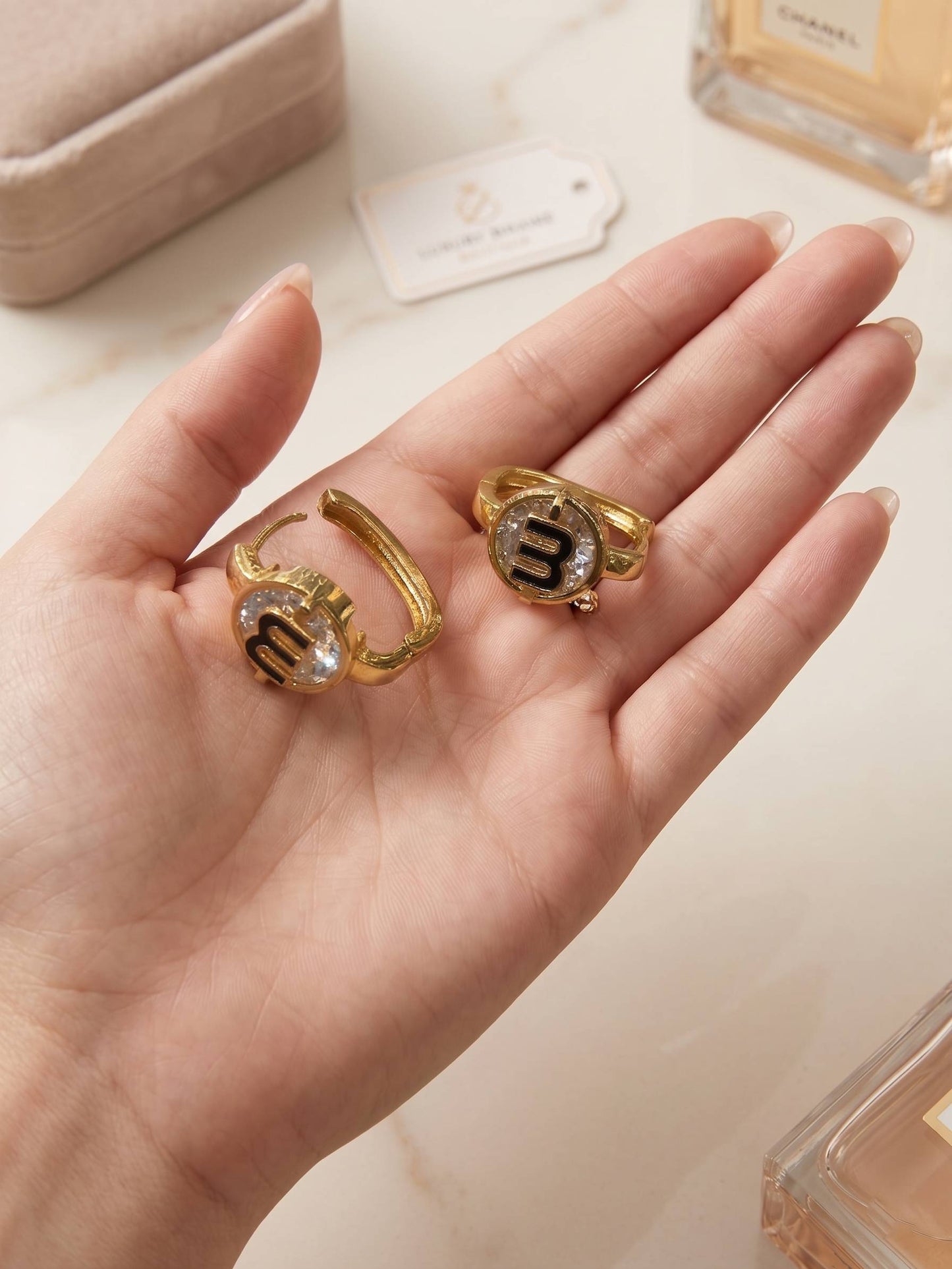 Gold rings with gemstones on a hand, with a blurred background