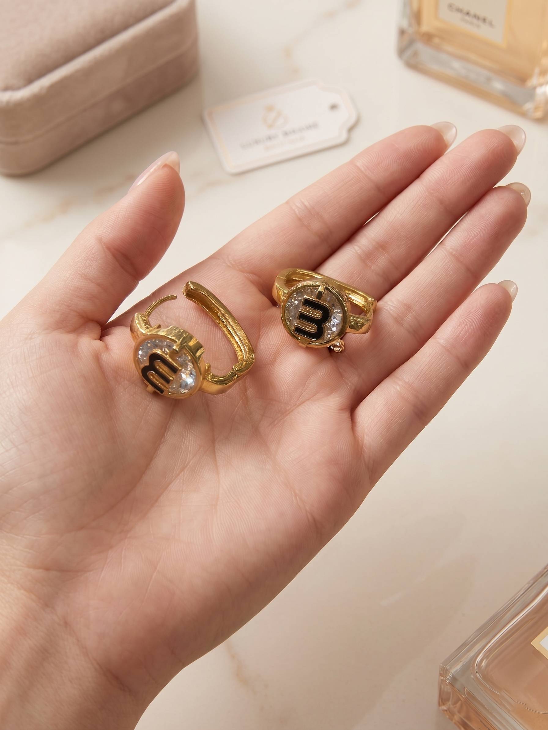 Gold rings with gemstones on a hand, with a blurred background