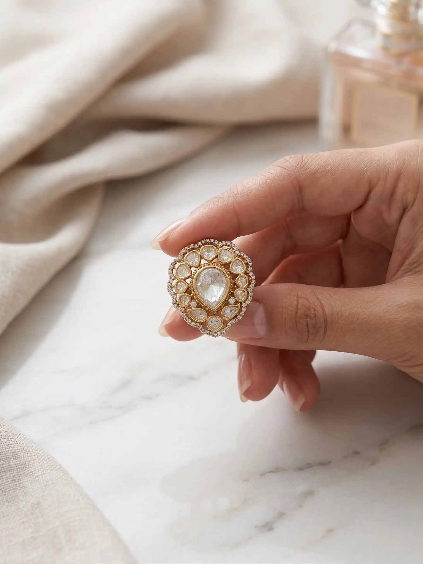 Luxury ladies rings: 8.66g adjustable Polki ring with clear stones and micro-diamond border shown on a woman's finger.