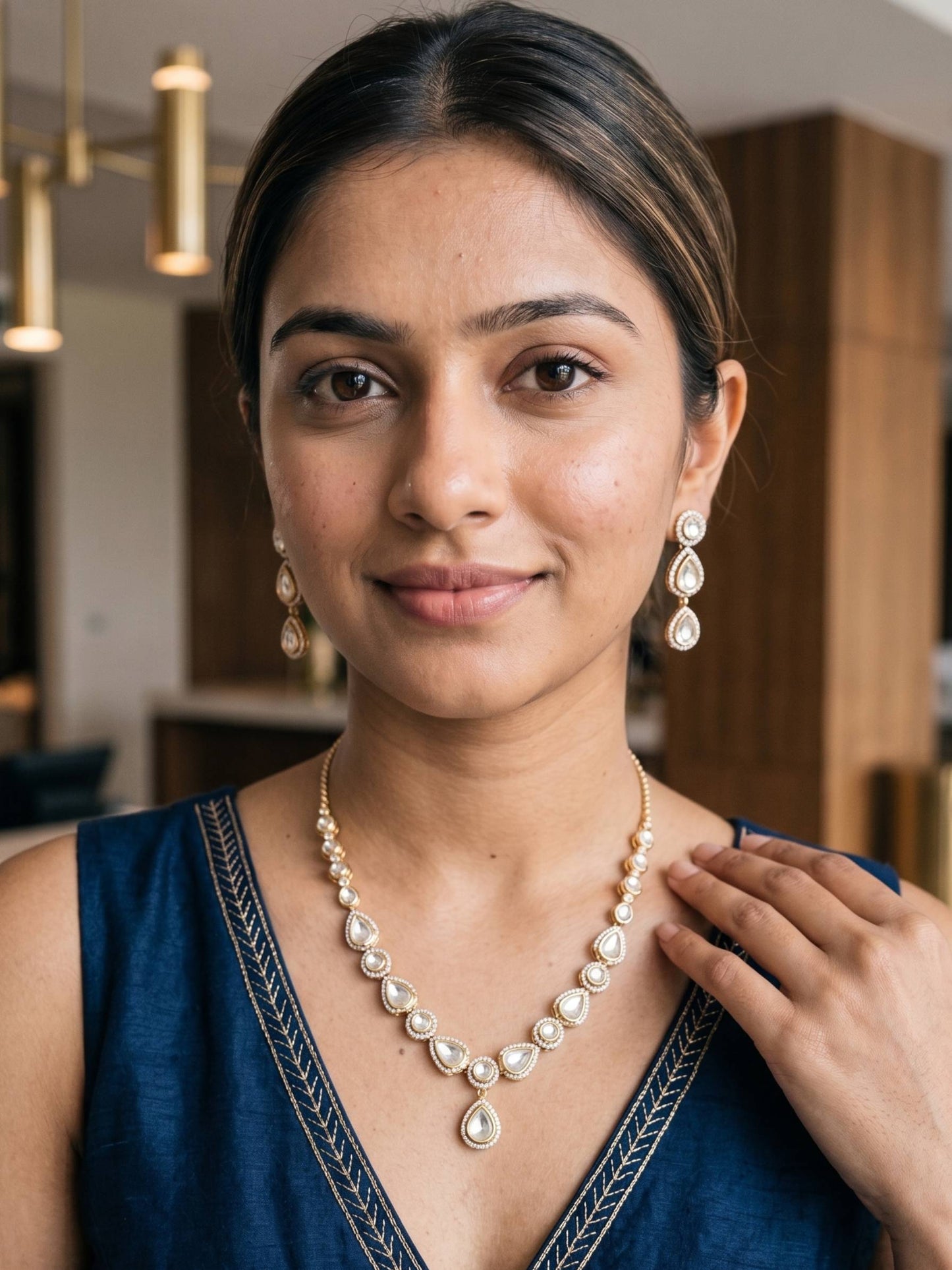 Woman wearing a pearl necklace and earrings indoors